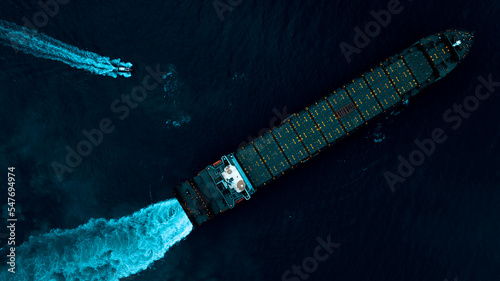 cargo ship test engine system after being repaired in dark sea, photograph over process art style, aerial top view
