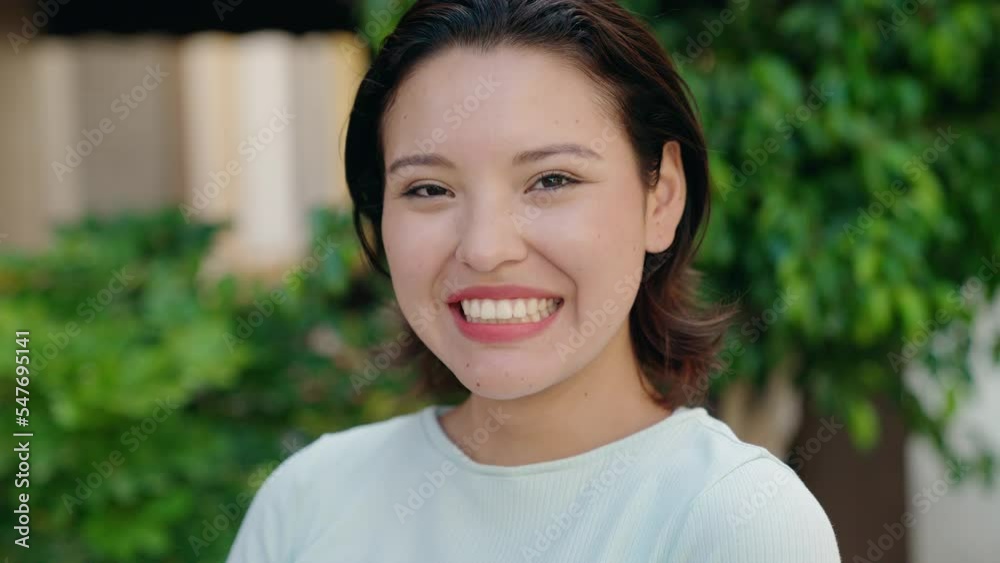 Young hispanic woman smiling confident standing at street Young hispanic woman smiling confident standing at street