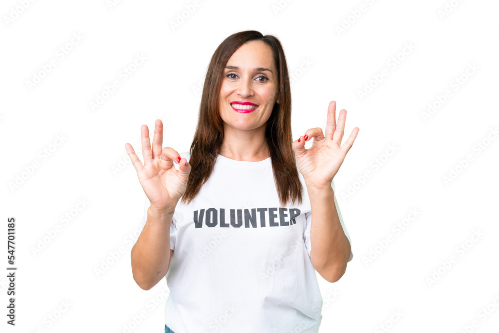 Middle age volunteer woman over isolated chroma key background showing an ok sign with fingers Middle age volunteer woman over isolated chroma key background showing an ok sign with fingers