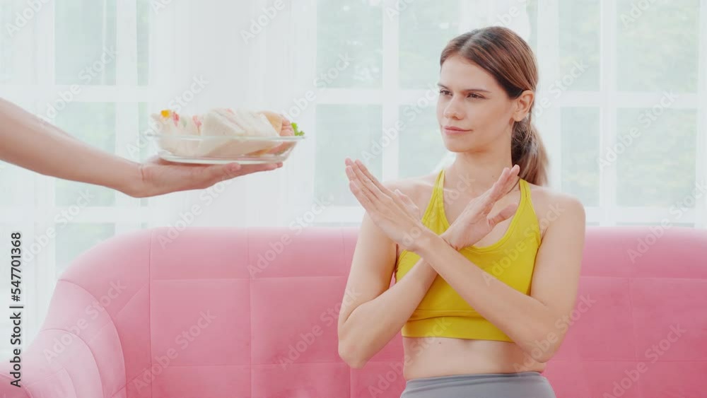 Hands serving food and young caucasian woman making sign say no food unhealthy with obese, woman refuse and push out food with temptation for dieting, nutrition and fast food a bad, health concepts. Hands serving food and young caucasian woman making sign say no food unhealthy with obese, woman refuse and push out food with temptation for dieting, nutrition and fast food a bad, health concepts.