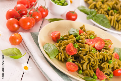 Fusilli pasta with cherry tomatoes and peas.