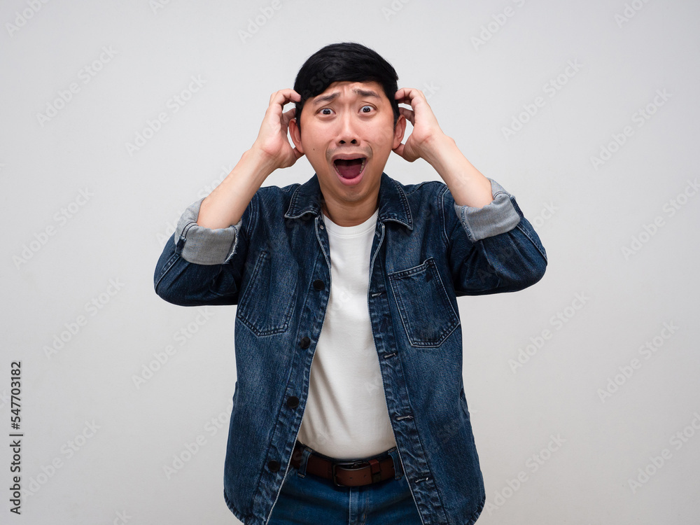 Asian man jeans shirt gesture hold his head feels shocked isolated Asian man jeans shirt gesture hold his head feels shocked isolated