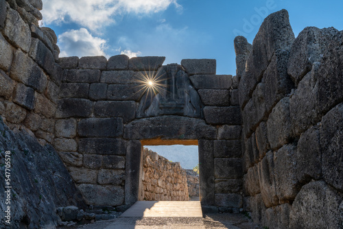 view of the Lion Gate entrance portal at the ancient citadel of Mycenae with a morning sunburst photo