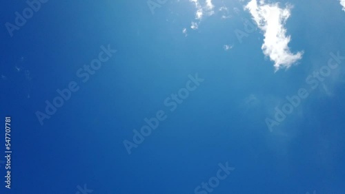 White fluffy and beautiful cumulus clouds like a cotton  freedom motion tranform to many shape on blue sky  in daytime  with sunshine ray nature cloudscape background summer season tropical time lapse photo