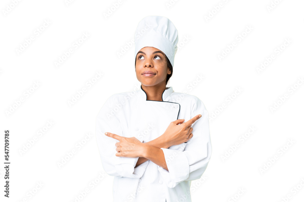 Young African American chef over isolated chroma key background pointing to the laterals having doubts Young African American chef over isolated chroma key background pointing to the laterals having doubts