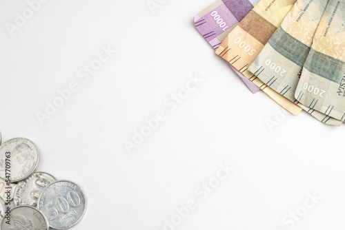 Indonesian rupiah paper and coin money on white plain background and empty negative for copy and text space. Uang receh Rupiah Indonesia official currency of Indonesia. photo