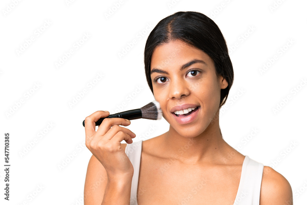Young woman over over isolated chroma key background holding makeup brush and surprised Young woman over over isolated chroma key background holding makeup brush and surprised