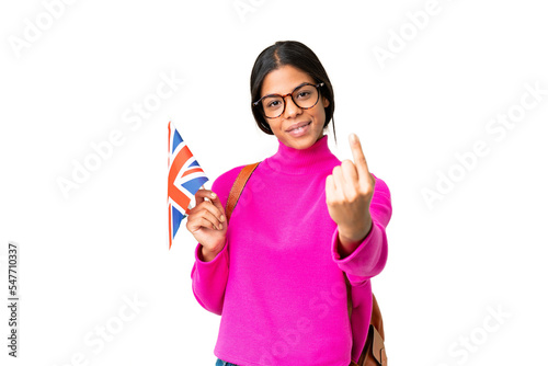 Young African American woman holding an United Kingdom flag over isolated chroma key background doing coming gesture