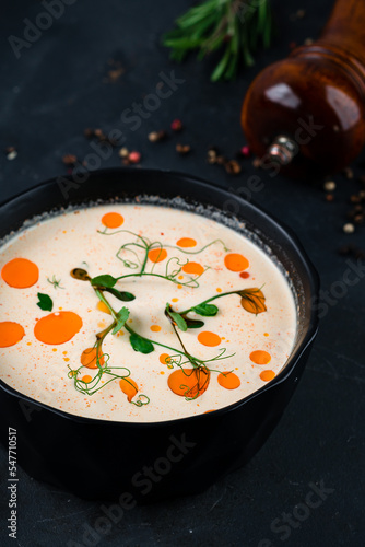 Fresh champignon cream soup served with green peas and oil.