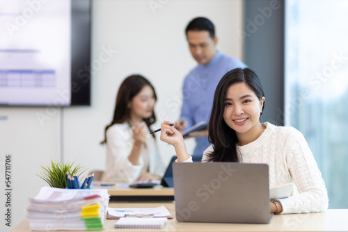 Portrait of a attractive business woman in a business office meeting room.