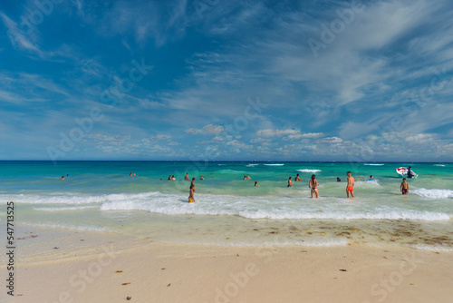 PLAYA DEL CARMEN, MEXICO - APR 2022: Sexy girl in string tanga bikini on the beach on a sunny day in Playa del Carmen, Yukatan, Mexico photo