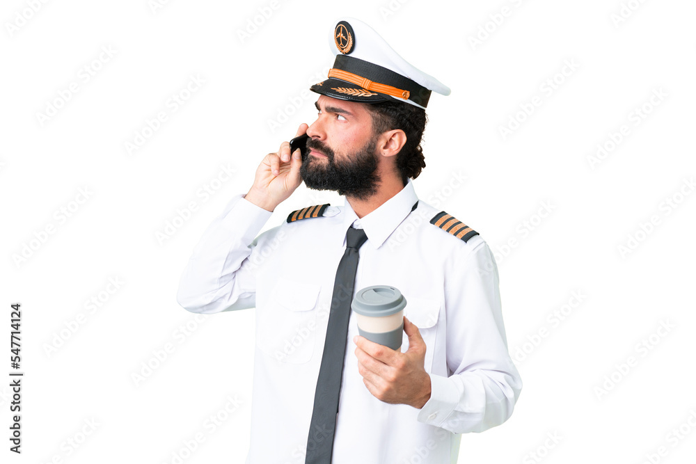 Airplane caucasian pilot man over isolated chroma key background holding coffee to take away and a mobile