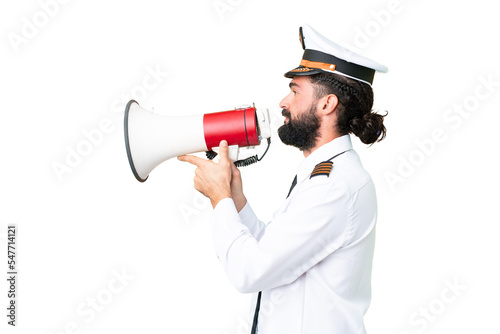 Airplane caucasian pilot man over isolated chroma key background shouting through a megaphone