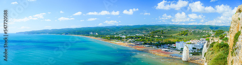 Vieste, Italy. Panoramic view from the top of the Lungomare Enrico Mattei beach with the famous Pizzomunno Monolith rising into the sea. Banner header. September 5, 2022.