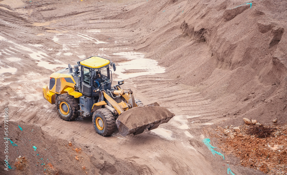 excavator loader machine during earthmoving works outdoors excavator loader machine during earthmoving works outdoors