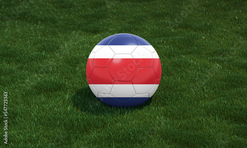 Soccer ball with Costa Rica flag colors at a stadium on green grasses background.