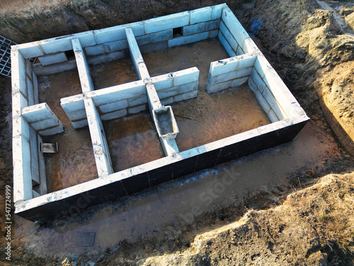 Construction of the foundation of the building from concrete blocks. view from above. drone photography. Prefabricated foundation of reinforced concrete blocks.