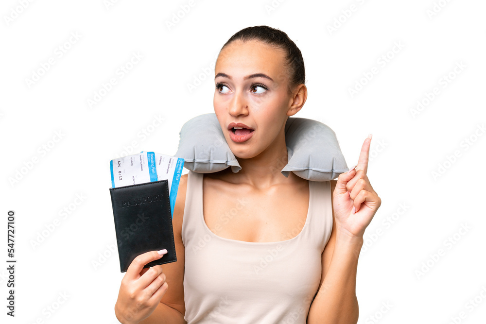 Young Arab woman with Inflatable Travel Pillow over isolated background thinking an idea pointing the finger up Young Arab woman with Inflatable Travel Pillow over isolated background thinking an idea pointing the finger up