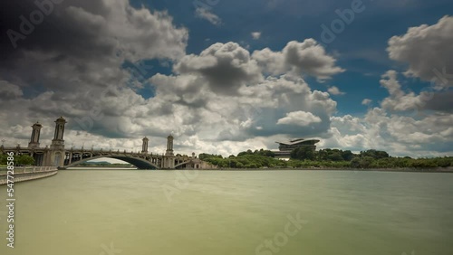Timelapse of Lake side view of Putrajaya International Convention Centre PICC Malaysia noon with marching clouds photo