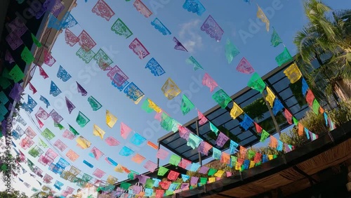 Festive flags flowing in wind overhead