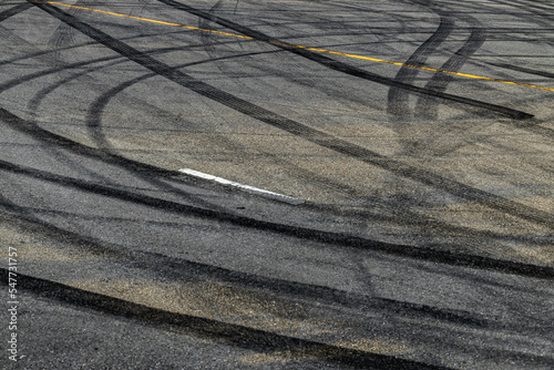 Tire track mark on asphalt tarmac road race track texture and background, Abstract background black tire tracks skid on asphalt road in racing circuit, Tire mark skid mark on asphalt road.
