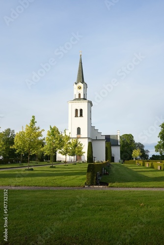 Vertical of a beautiful landscape displaying the tower building Risinge parish church in Sweden photo