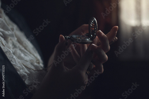 Female hands hold vintage round clock, steampunk style, closeup