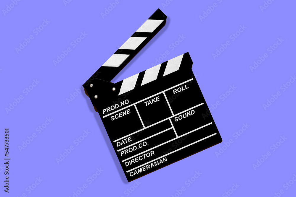 Clapperboard for shooting video footage takes on a lilac background