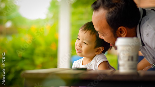 Happy asian father and little son having fun together , enjoying weekend, funny activities together close up .
