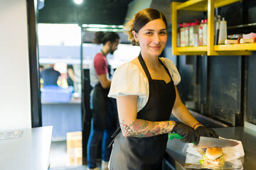 Portrait of a smiling woman chef working at the food truck