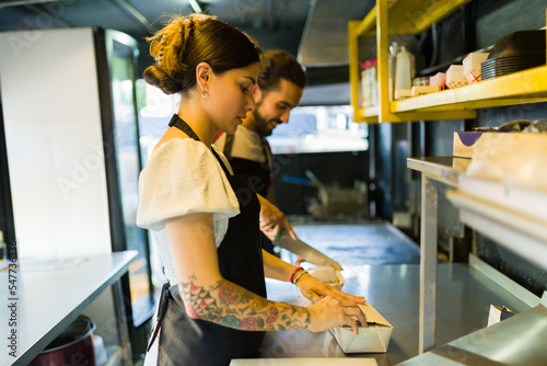 Food truck workers working preparing street food