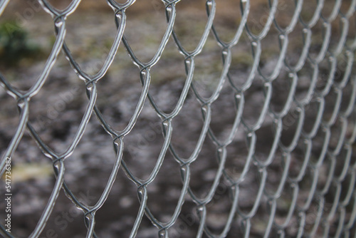 metal fence mesh covered with ice bad weather