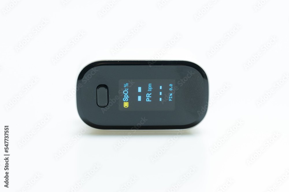 Woman resting at home using pulse oximeter to monitor blood oxygen levels and pulse rate on white background.Finger inserted into the pressure oximeter to assess health from the living room home. Woman resting at home using pulse oximeter to monitor blood oxygen levels and pulse rate on white background.Finger inserted into the pressure oximeter to assess health from the living room home.