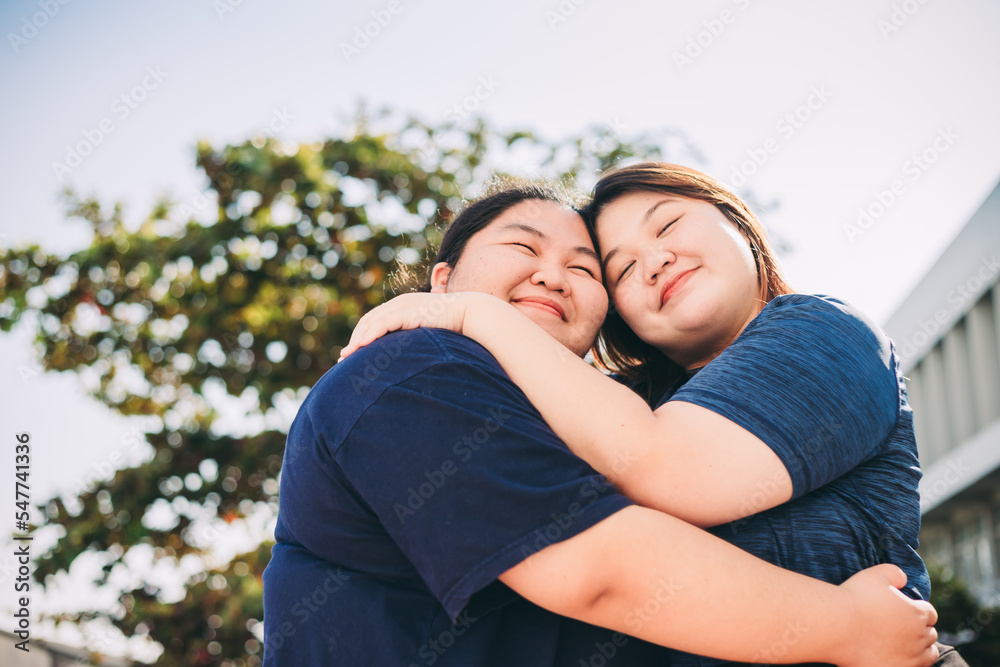 Fototapeta premium Friendship young girls have fun and hug in outdoor - portrait of couple of caucasian females stay together in love - lgbt people free rights concept.