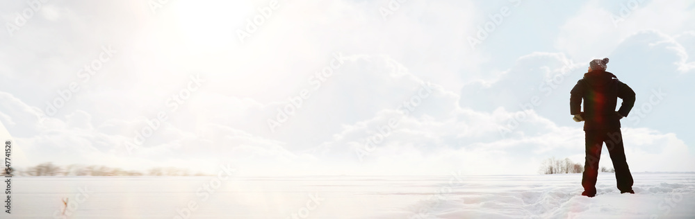 Fototapeta premium A man on a walk. Winter landscape. Tourist in winter journey.