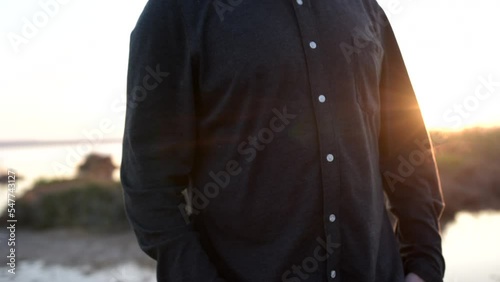 Wallpaper Mural Adult man in black with his hands in his pockets and a lake behind him Torontodigital.ca