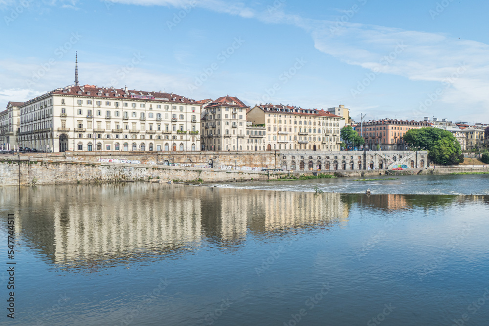 The murazzi of Turin with the palaces that are reflected in the water of the river Po