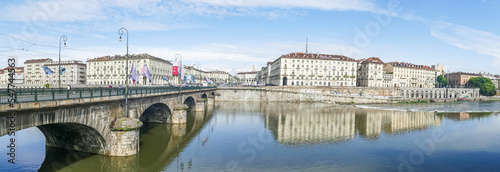 The murazzi and the Vittorio Emanuele bridge of Turin are reflected in the water of the river Po