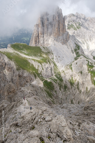 Various climbers climbing on the rock of the via ferrate of the mountain Rotwand in the Italian Dolomites mountains. photo