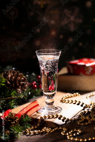 Celebration of Christmas and New Year with champagne. Decorated Christmas table. Champagne glass