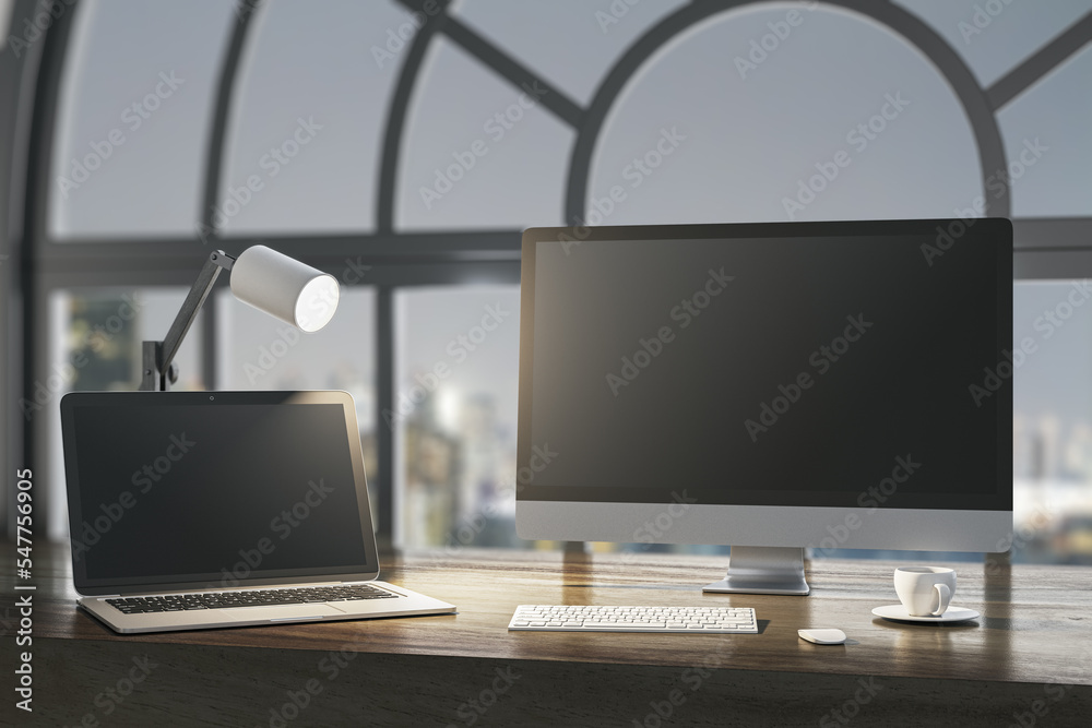 Fototapeta premium Close up of night designer desktop with empty laptop computer screens, coffee cup and keyboard on wooden desktop and window with city view background. Mock up, 3D Rendering.