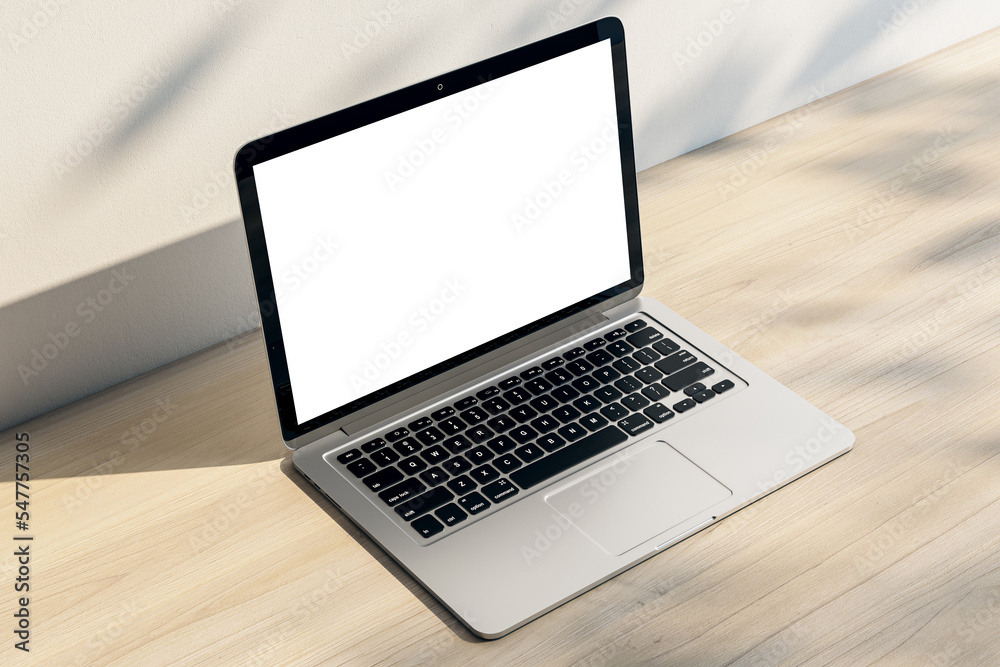 Perspective view on blank white laptop screen with space for your logo or text on light wooden surface and sunlit light wall background. 3D rendering, mock up Perspective view on blank white laptop screen with space for your logo or text on light wooden surface and sunlit light wall background. 3D rendering, mock up