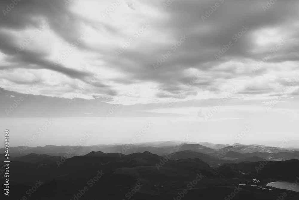 Fototapeta premium Dramatic black and white view of mountain range and cloudscape