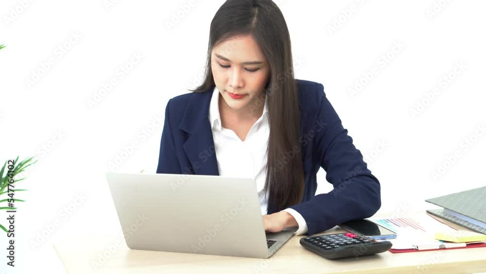 Asian businesswomen attractive and young, working by using a computer to make a report and record business information at workplace. Asian businesswomen attractive and young, working by using a computer to make a report and record business information at workplace.
