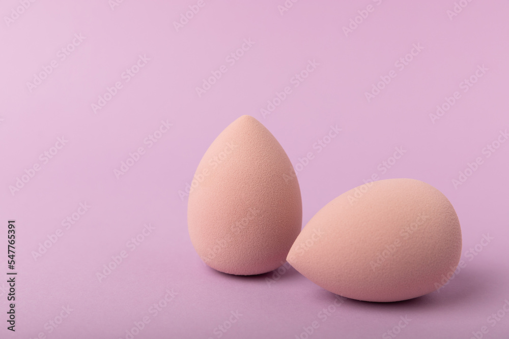 Beauty blender. Cosmetic sponge on a lilac background. MOCAP. Sponge for applying foundation and concealer. Beauty concept. Space for text. Space for copy space.