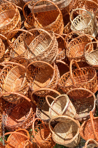 Many wicker baskets are stacked in one place.