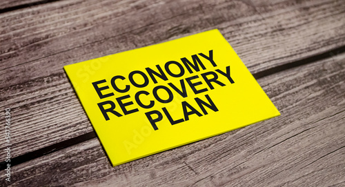 ECONOMY RECOVERY PLAN CONCEPT. Text on business paper on office table