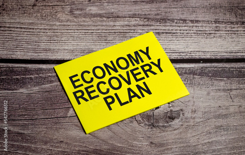 ECONOMY RECOVERY PLAN CONCEPT. Text on business paper on office table