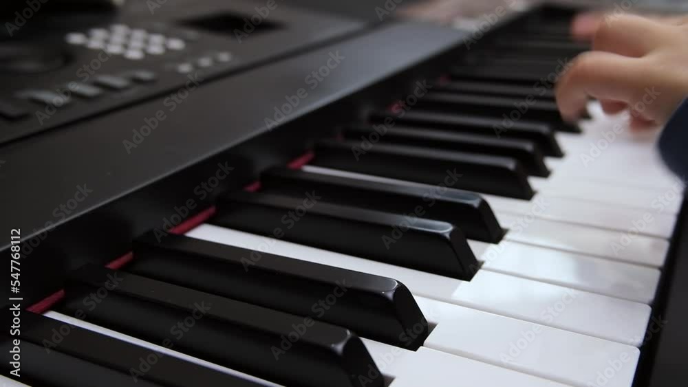 Children's fingers play on the keys of a piano synthesizer. Selective focus on piano keys. High quality FullHD footage Children's fingers play on the keys of a piano synthesizer. Selective focus on piano keys. High quality FullHD footage