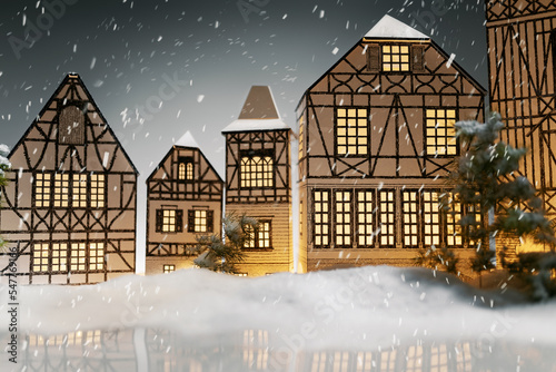 Lantern village city with falling snow, frozen lake and fir trees